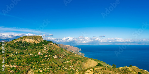 evening sunset mountain view of hightland landscape with green hills and mountains and amazing blue sea water with beautiful cloudy sky on background photo