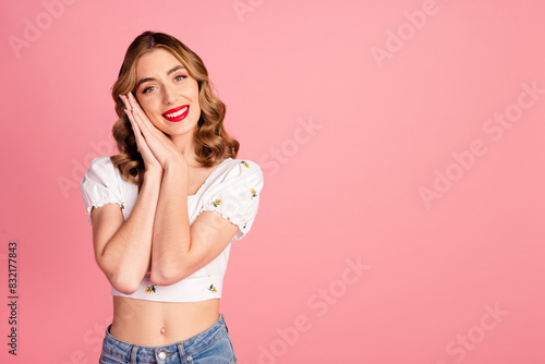 Photo portrait of pretty young girl hands together dreamy wear trendy white outfit hairdo isolated on pink color background