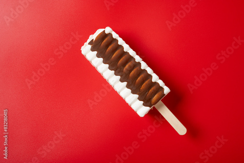 top view vanilla and chocolate flavor popsicle on a red background photo