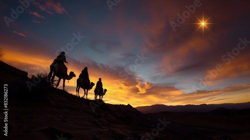 Silhouette of the three wise men on their camels walking through the desert at sunset  following the star towards the Bethlehem portal.copy space