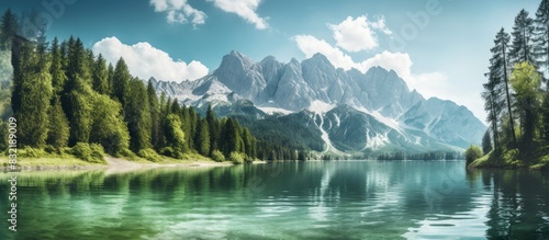 View of zugspitze with forrest and lake in foreground. Creative banner. Copyspace image photo