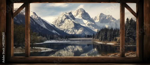 Snowcapped mountains and landscape with river through old wooden window from bridge. Creative banner. Copyspace image