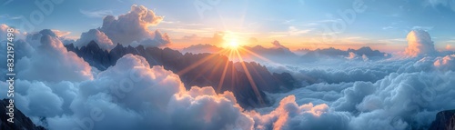 Ethereal view of sun rays piercing through fluffy clouds at dawn, highlighting the peaks of rugged mountains below photo
