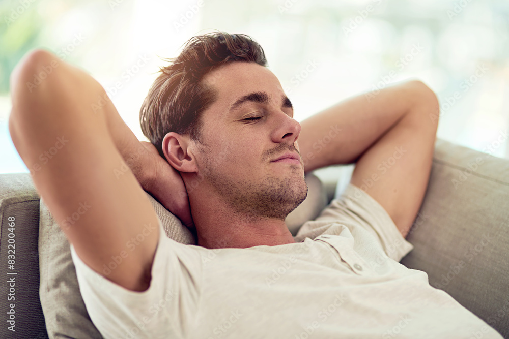 Obraz premium Man, sleeping and couch in rest for wellness, health and comfort in home with tired or fatigue. Male person, nap and lounge for relax, burnout or calm in peaceful, break in eyes closed in living room
