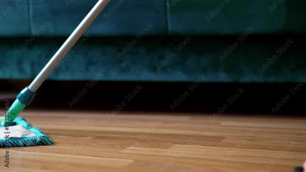 Cleaning the floor with a mop closeup. Hosehold and clean home concept. Cleaning the floor with a mop closeup. Hosehold and clean home concept.