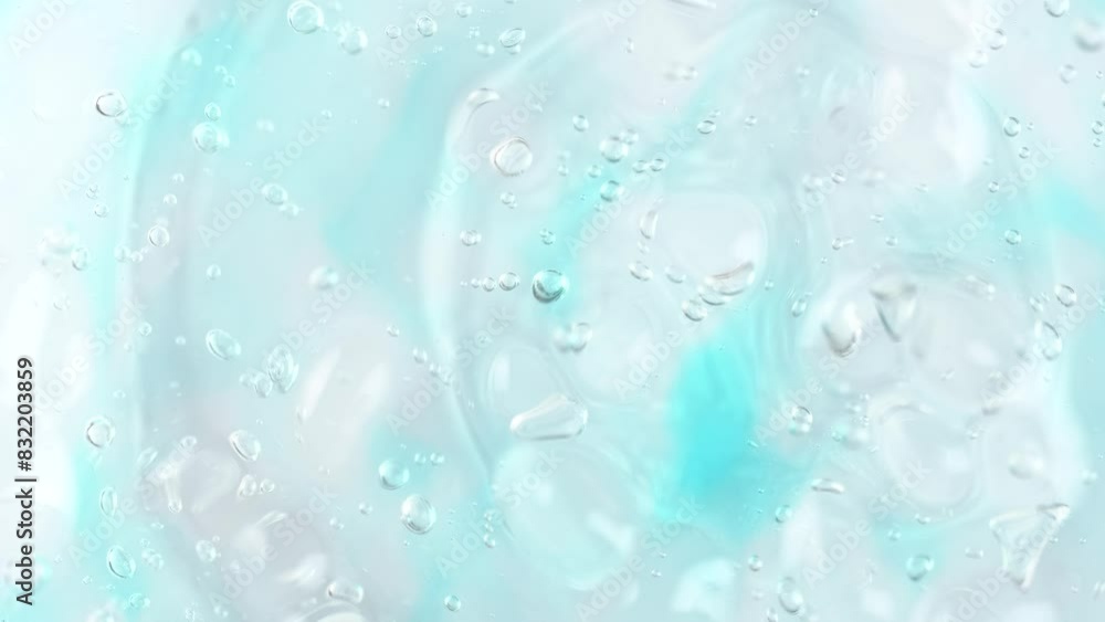 Transparent gel fluid with blue and white bubbles, rotating. Macro texture of cleansing gel or shower gel Transparent gel fluid with blue and white bubbles, rotating. Macro texture of cleansing gel or shower gel