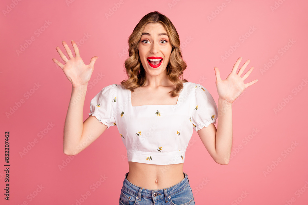 Photo portrait of lovely young woman raise hands excited dressed stylish white garment hairdo isolated on pink color background Photo portrait of lovely young woman raise hands excited dressed stylish white garment hairdo isolated on pink color background