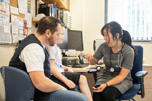 Healthcare professional conducting a checkup with a young patient photo