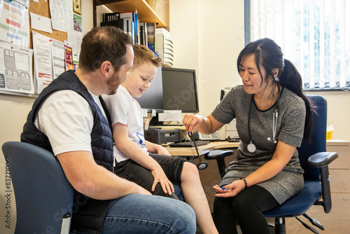 Healthcare professional conducting a checkup with a young patient photo