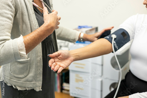 Nurse taking a patient's blood pressure photo