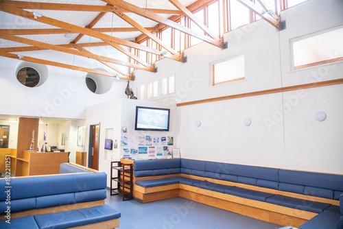 Modern waiting area with comfortable seating and informational displays in a hospital, UK.