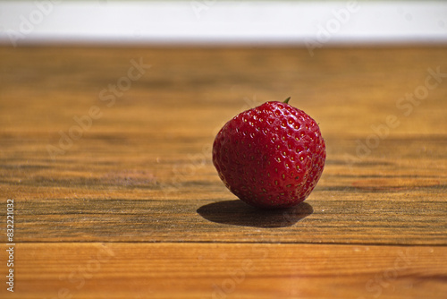 Red fresh strawbery on woden plank. Czerwona świeża truskawka na drewnianej desce