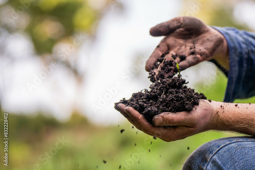 farmer hold soil in hands monitoring soil health on a farm.in australia photo