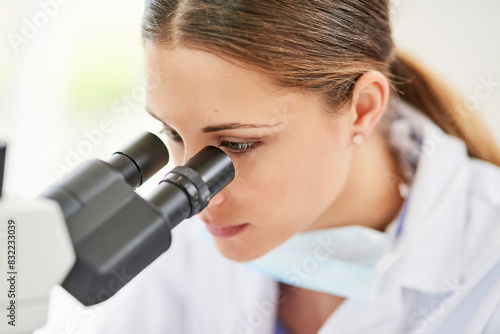 Scientist, woman and microscope in laboratory for innovation, medicine and test in clinic. Investigation, analysis and research in hospital for healthcare, biotechnology and pharmaceutical career