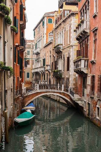 Narrow canals of Venice city with old traditional architecture, bridges and boats, Veneto, Italy. Tourism concept. Architecture and landmark of Venice. Cozy cityscape of Venice.