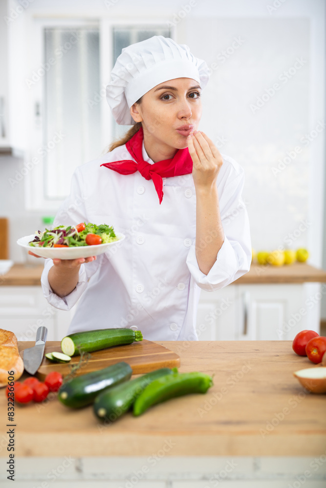 Female chef demonstrating excellent salad in the kitchen Female chef demonstrating excellent salad in the kitchen