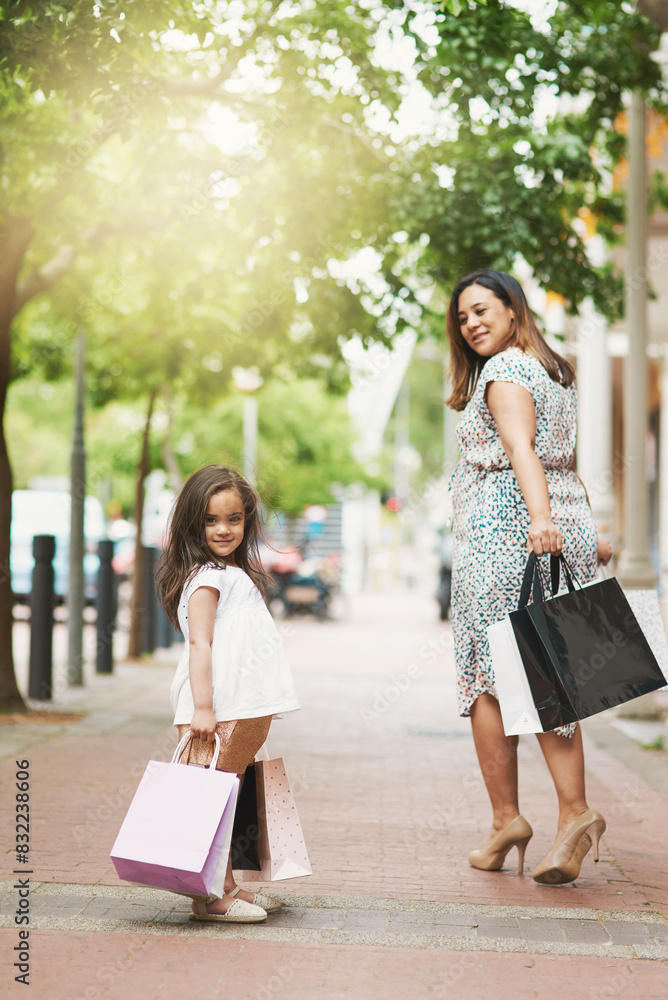 Portrait, mother and young girl shopping bags outdoor together for fashion, retail and style trends. Happy, parent and kid outside carrying clothes or gift apparel for summer sale or discount Portrait, mother and young girl shopping bags outdoor together for fashion, retail and style trends. Happy, parent and kid outside carrying clothes or gift apparel for summer sale or discount