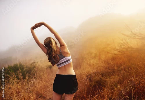 Obraz Mountain, woman or runner stretching in nature for fitness training, wellness or exercise outdoors. Back, trail and healthy female athlete in body warm up to start running or cardio workout on hill