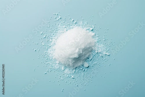 Pile of white granulated sweetener on blue