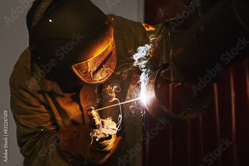 Close-up image of industrial worker at the factory welding.