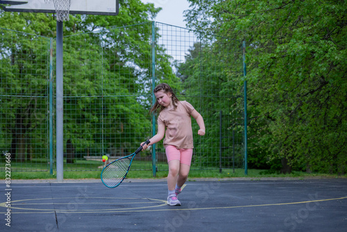 A little girl plays speed badminton