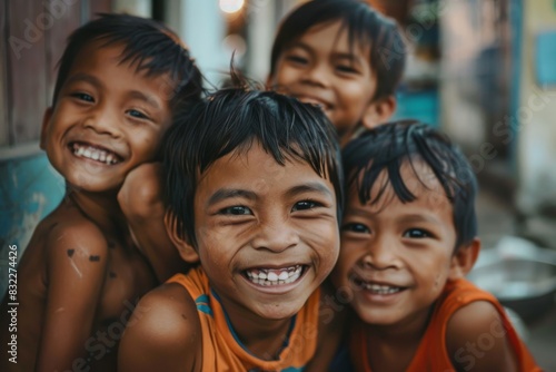 Portrait of a group of asian children smiling at camera. © Iigo