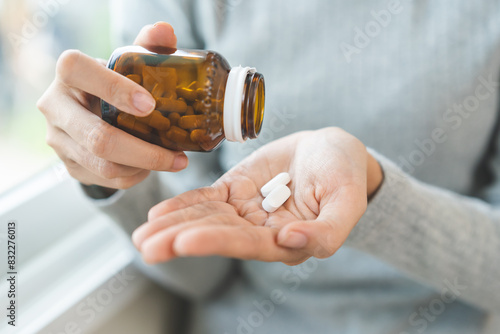 Tableau sur toile Sick ill asian young woman, girl hold tablet pill on hand pour capsule from medication bottle, painkiller medicine from stomach pain, head ache, pain for treatment, take drug or vitamin, health care