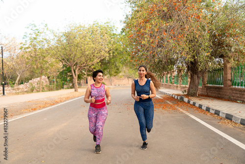 Two fit Young sporty indian women running outdoor morning workout exercise, Fitness and sport, Burn calories, Daily routine.Healthy lifestyle.