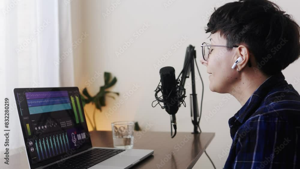 Woman recording audio podcast with microphone and laptop computer at