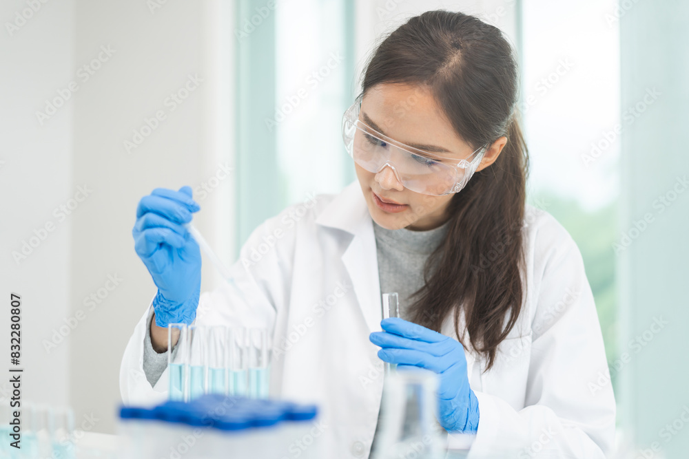 Medical development research laboratory, chemist or science scientist student hand in glove, drop water into pipette for test analysis liquid sample in clinic lab. Microbiology, analysing for medicine Medical development research laboratory, chemist or science scientist student hand in glove, drop water into pipette for test analysis liquid sample in clinic lab. Microbiology, analysing for medicine