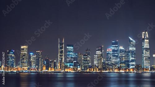 City skyline at night with illuminated buildings