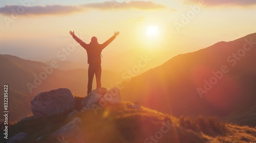 Man with arms up celebrating on top of the mountains - Hiker enjoying freedom on a hill at sunset - Freedom, sport, success and mental health concept 
