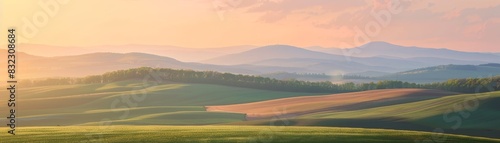 Beautiful rolling hills with lush greenery and a breathtaking sunrise in the background, creating a serene and picturesque landscape.