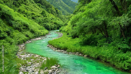 Crystal clear stream winding through a lush valley  with emerald green vegetation lining its banks
