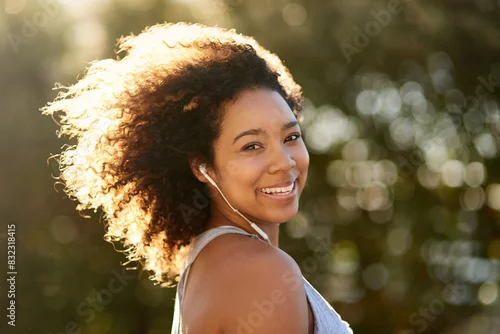 Obraz Portrait, runner and black woman outdoor with earphones for streaming music, listening or podcast or radio. Playlist, sports and athlete with smile for cardio training, morning workout or fitness