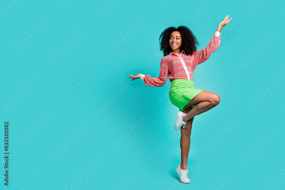 Full length photo of adorable funky girl wear print shirt having fun empty space isolated teal color background