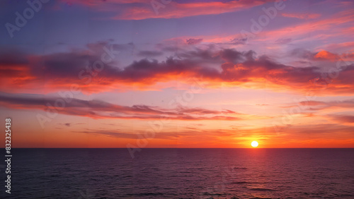 Vibrant sunset over tranquil ocean horizon