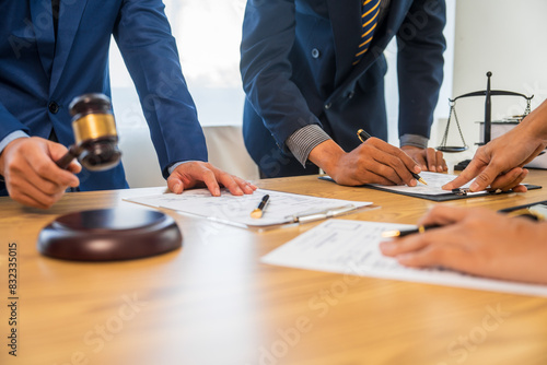 Cuadro en lienzo A team meeting of business people and a lawyer in formal suits is taking place at a desk, discussing a contract and various aspects of the law and litigation
