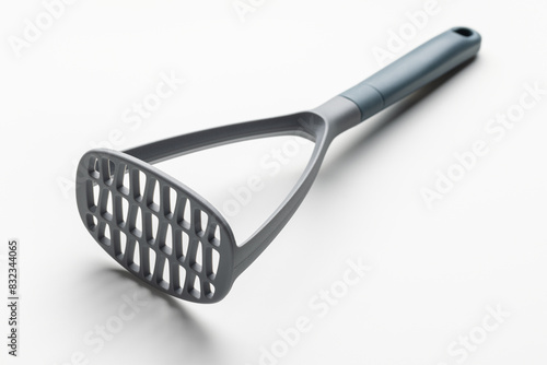 Plastic potato masher for making mashed potatoes. Kitchen utensils on white. photo