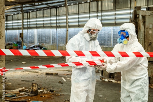 Man inspector scientist investigate chemical gas leak spill with safety face mask PPE suit in area closed barricade security red white tape. danger area infected toxic leak spill cross stripe ribbon