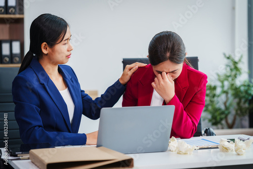 Photography Two Asian businesswomen under stress and pressure discuss financial matters, experiencing anxiety and worry while navigating the complexities of the stock market and loan applications