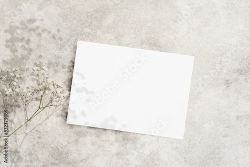 Wedding invitation card mockup with dry gypsophila flowers decor, copy space for card design presentation