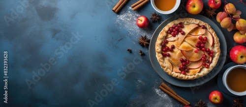 Whole apple pie for autumn coffee break Bakery food fresh red apples cinnamon espresso cup honey in bowl on blue concrete table background Traditional seasonal dessert autumn harvest flat lay photo