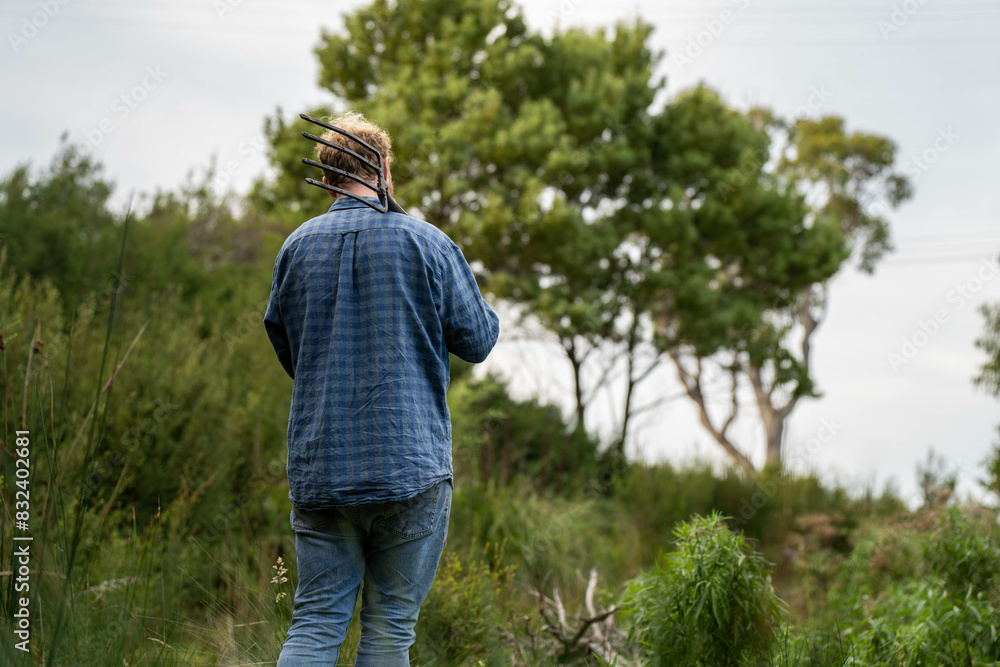university student conducting research on forest health. farmer collecting soil samples in a test tube in a field. Agronomist checking soil carbon and plant health on a farm in australia university student conducting research on forest health. farmer collecting soil samples in a test tube in a field. Agronomist checking soil carbon and plant health on a farm in australia