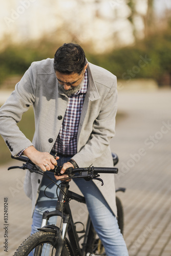Man Fixing the Handlebars of His Bicycle Before Riding