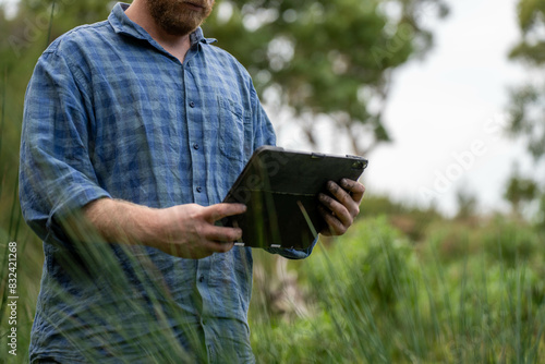 farmer holding soil taking a soil sample for a soil test in a field. Testing carbon sequestration and plant health in Australia photo