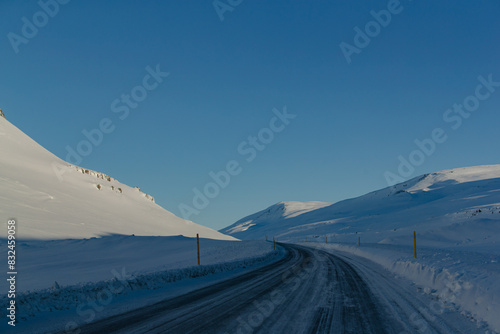 Wallpaper Mural Snowy road winding through open countryside under blue sky Torontodigital.ca