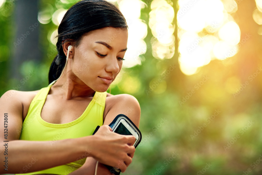 Outdoor, woman and cellphone for music before fitness, running and exercise for wellness with goals. Nature, female runner and headset for listening to podcast, radio and change playlist on mobile Outdoor, woman and cellphone for music before fitness, running and exercise for wellness with goals. Nature, female runner and headset for listening to podcast, radio and change playlist on mobile