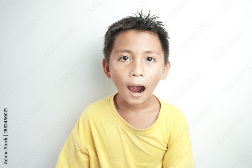 Portrait of a cute little Asian boy smiling against white background Portrait of a cute little Asian boy smiling against white background