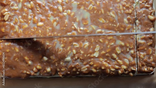 Cutting caramel peanut cake. Woman's hand cuts cake